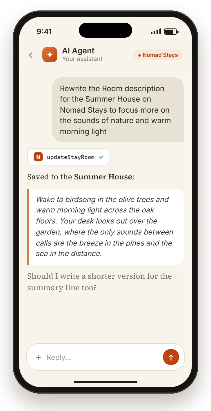 Phone screen: a Stay partner asks their AI agent &ldquo;Rewrite the Room description for the Summer House on Nomad Stays to focus more on the sounds of nature and warm morning light&rdquo; and the agent replies using Nomad Stays